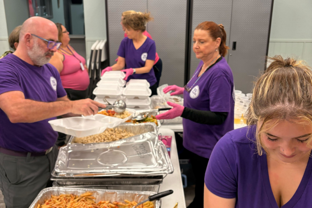 Matthew's Hope volunteers prepare food at the Winter Garden outreach center.