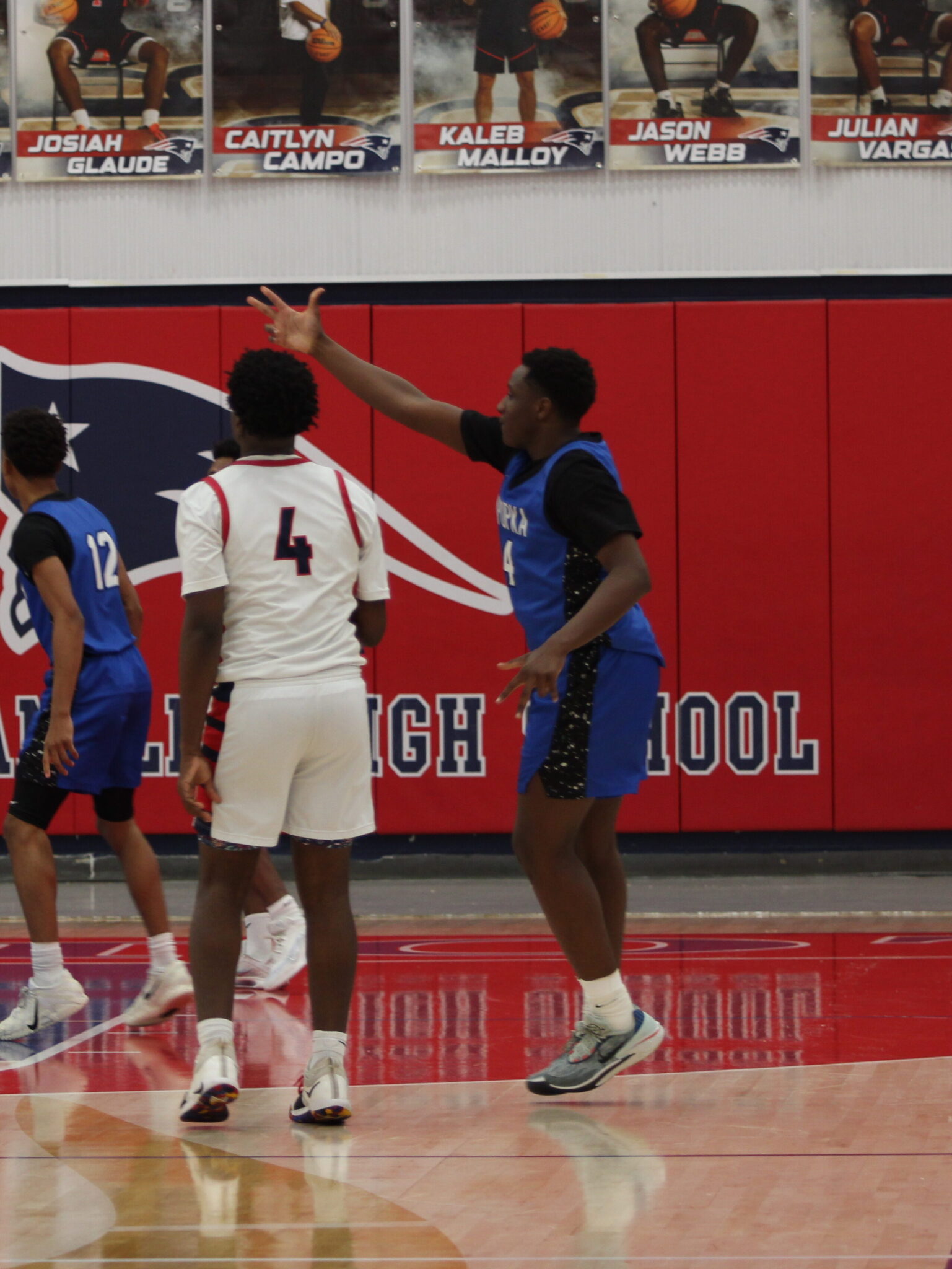 Zee Davis quiets the crowd and points to them with 3