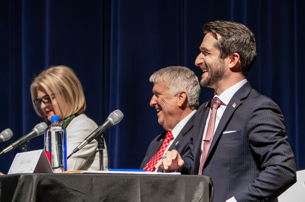 Candidates laugh at the Feb. 3 mayoral debate.