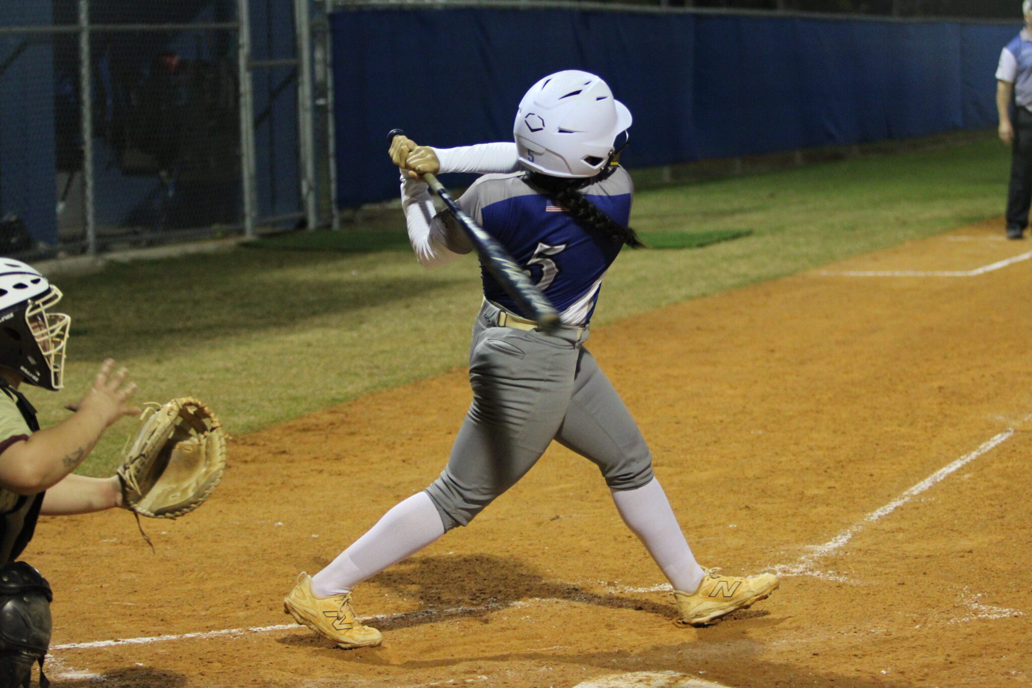 Alicia Lopez follows through on her perfect swing that nuked the ball over the left field fence