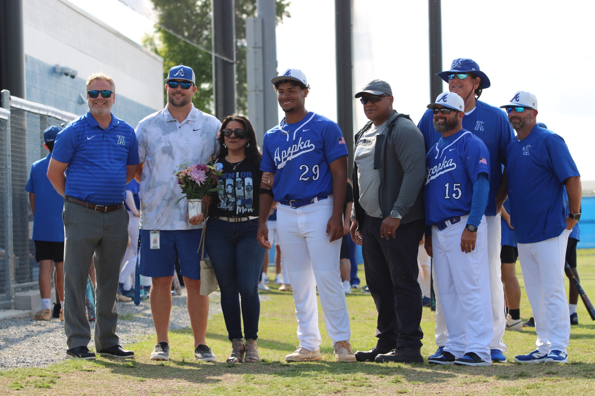 Andy Diaz with his mother, father, coaches, Athletic Director Jordan Walker, and Principal Heinz on senior night
