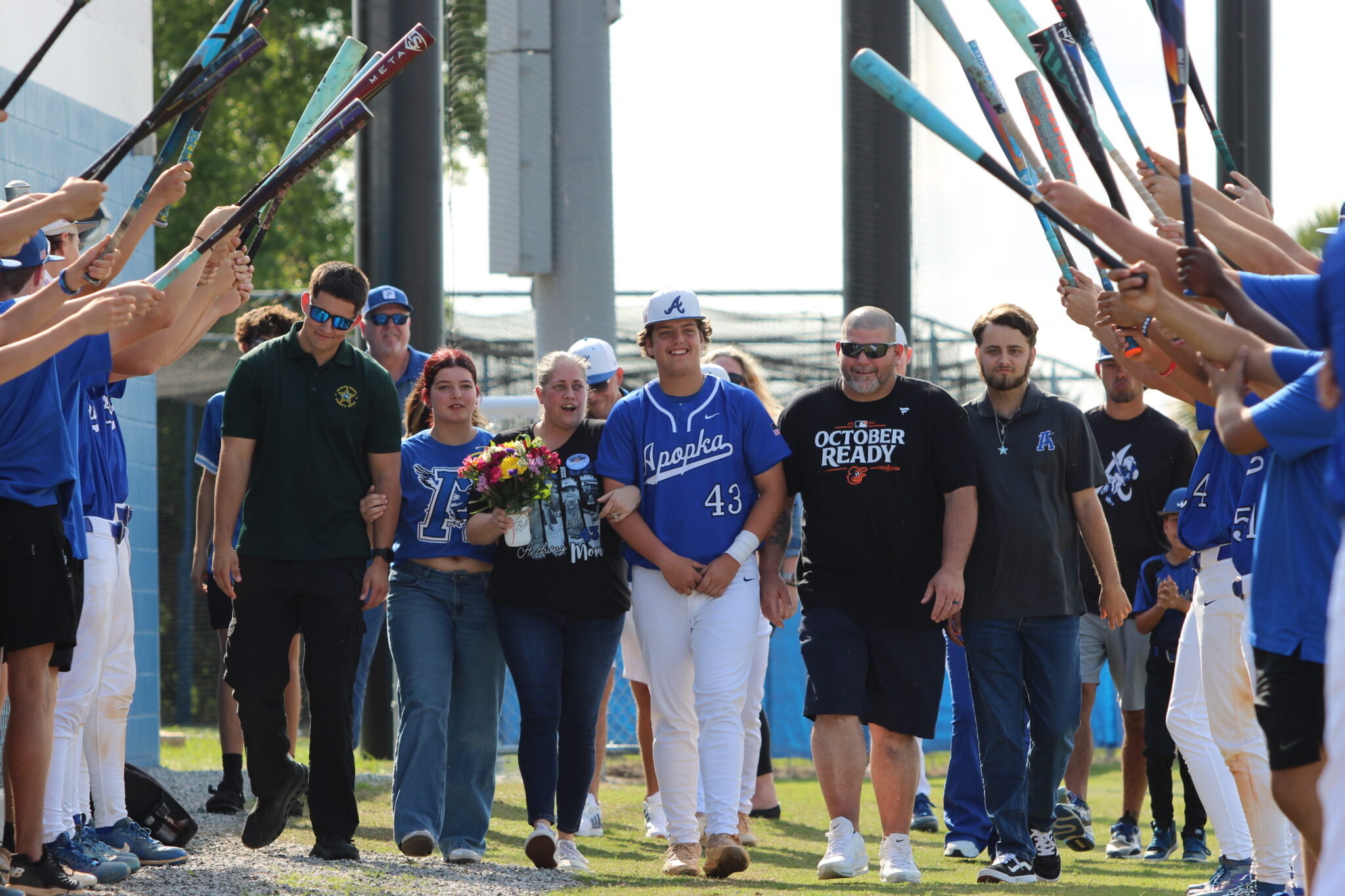 Anthony Raymond walks out with his family on senior night