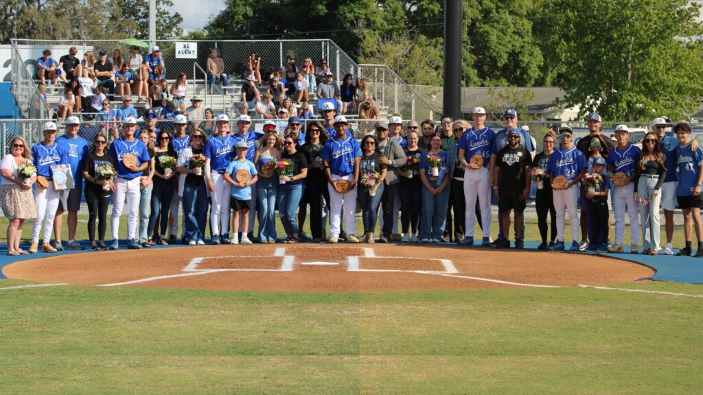 Apopka Blue Darters Class of 2026 pose with their families for a group photo