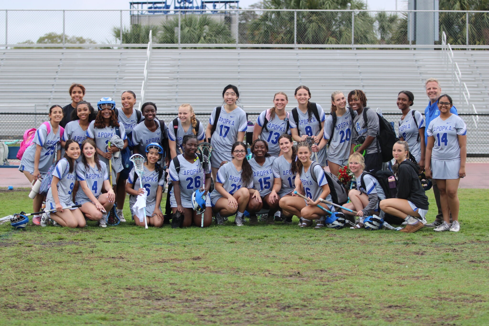 Apopka Blue Darters girls lacrosse team poses after their senior night game with Principle Heinz