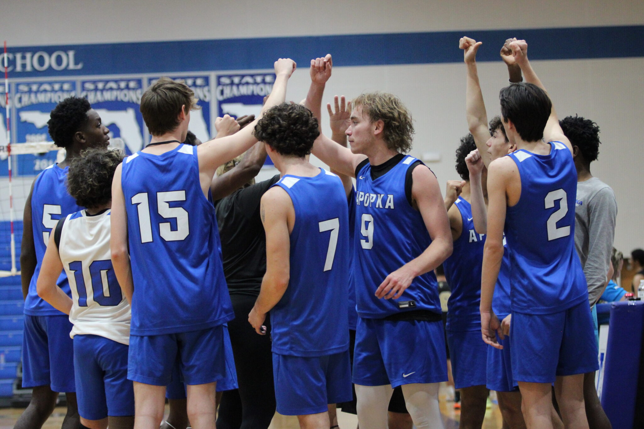 Apopka Blue Darters huddle ahead of the fourth set