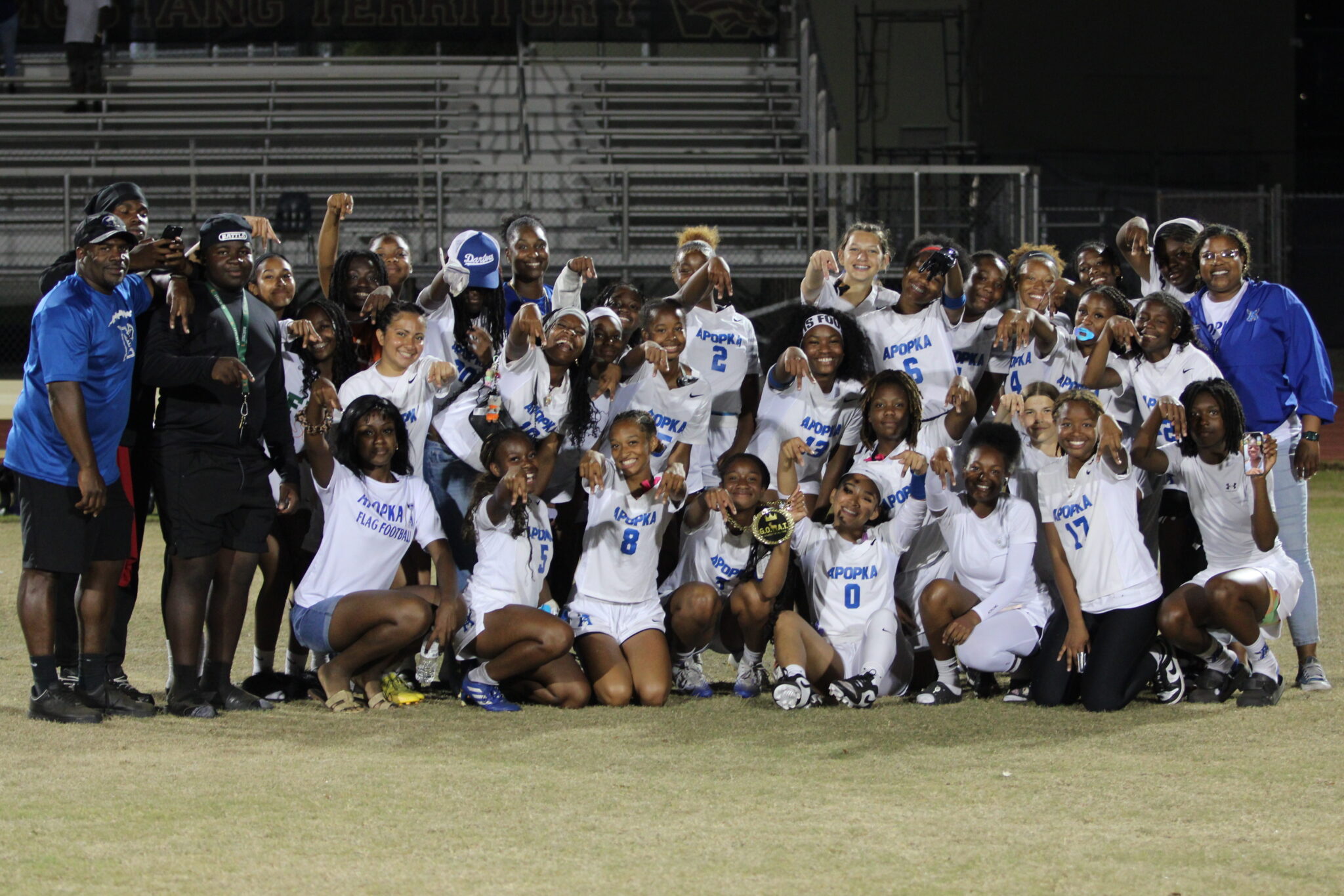 Apopka Blue Darters pose with an A after their victory against Wekiva, Mikayla Wiggins receives the GOAT Chain