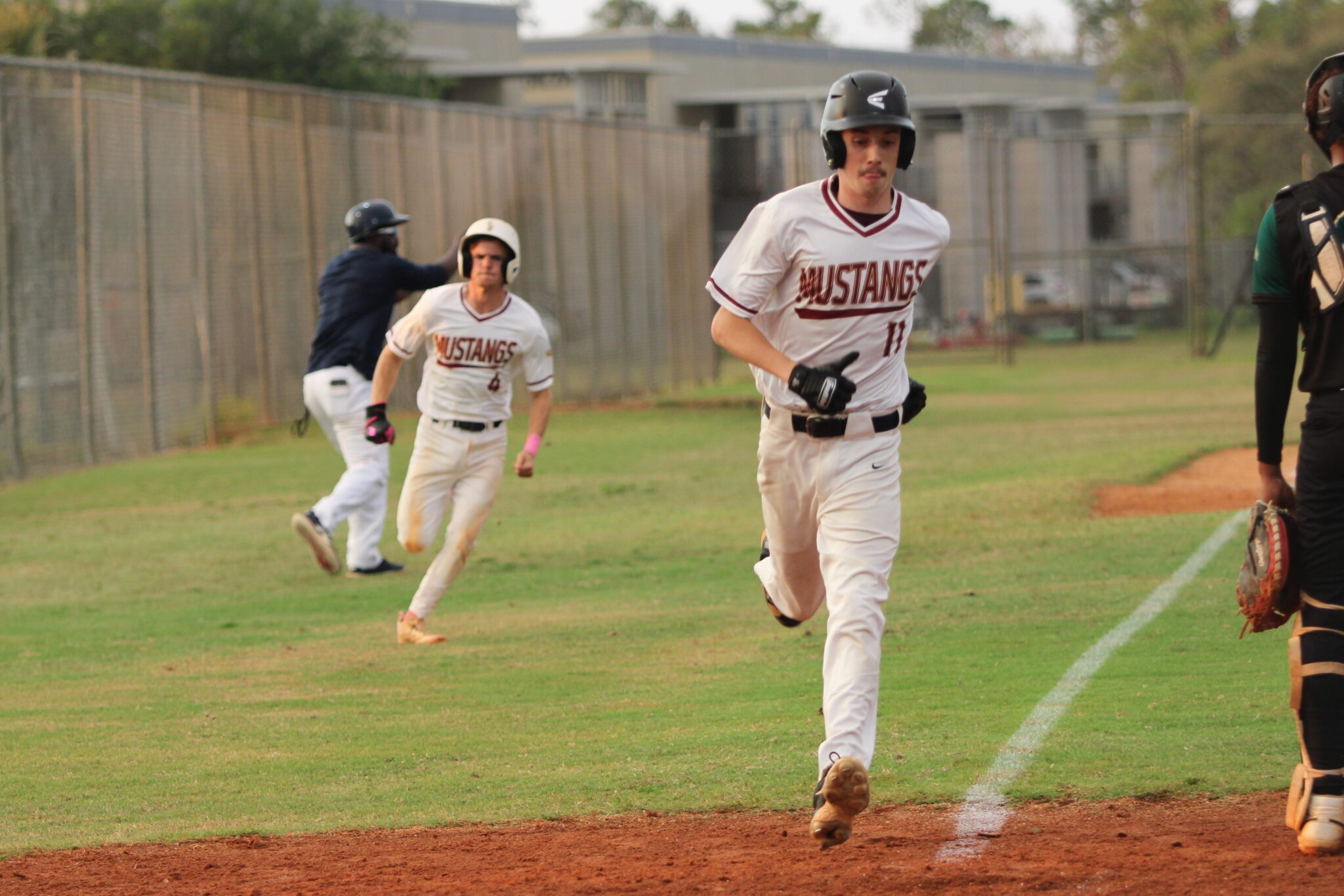 Blane Byrd runs home from third as Brady Reinert blasts through third base and makes it home