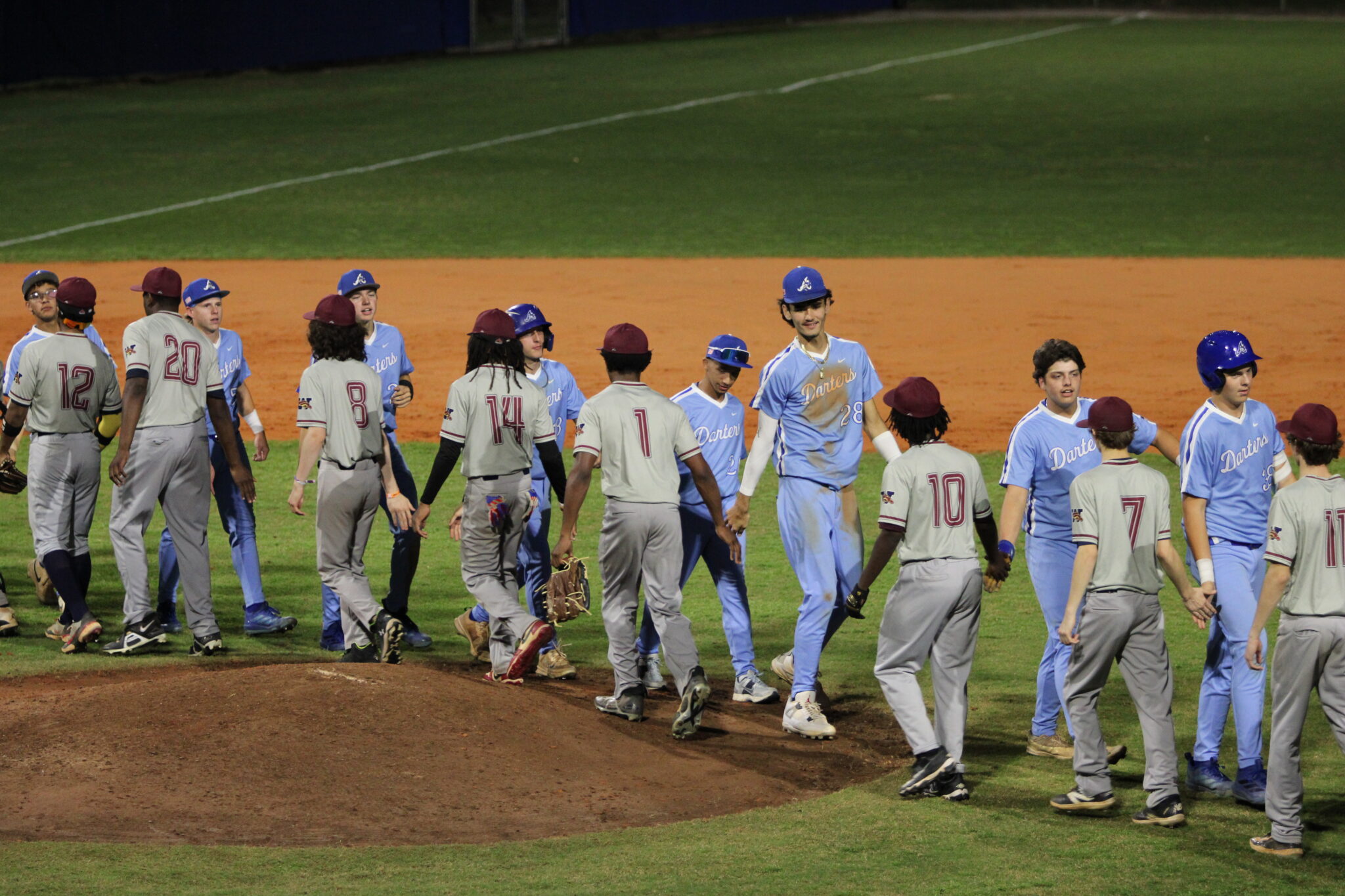 Blue Darters and Mustangs show sportsmanship with a shake of hands at the end of the game