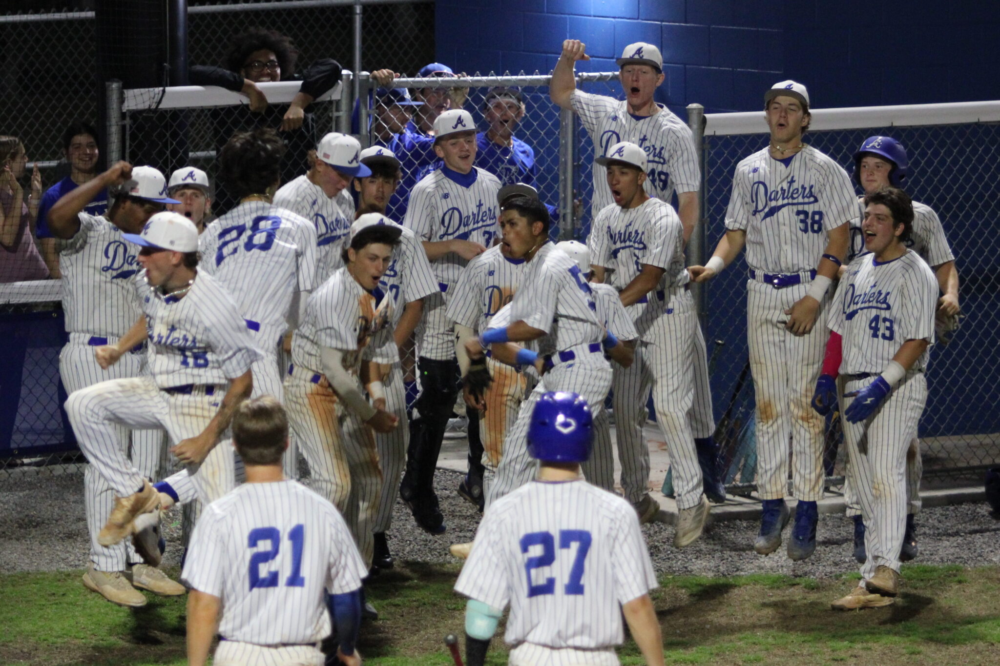 Blue Darters celebrate Tyler Spaid's late homerun to continue their rally back