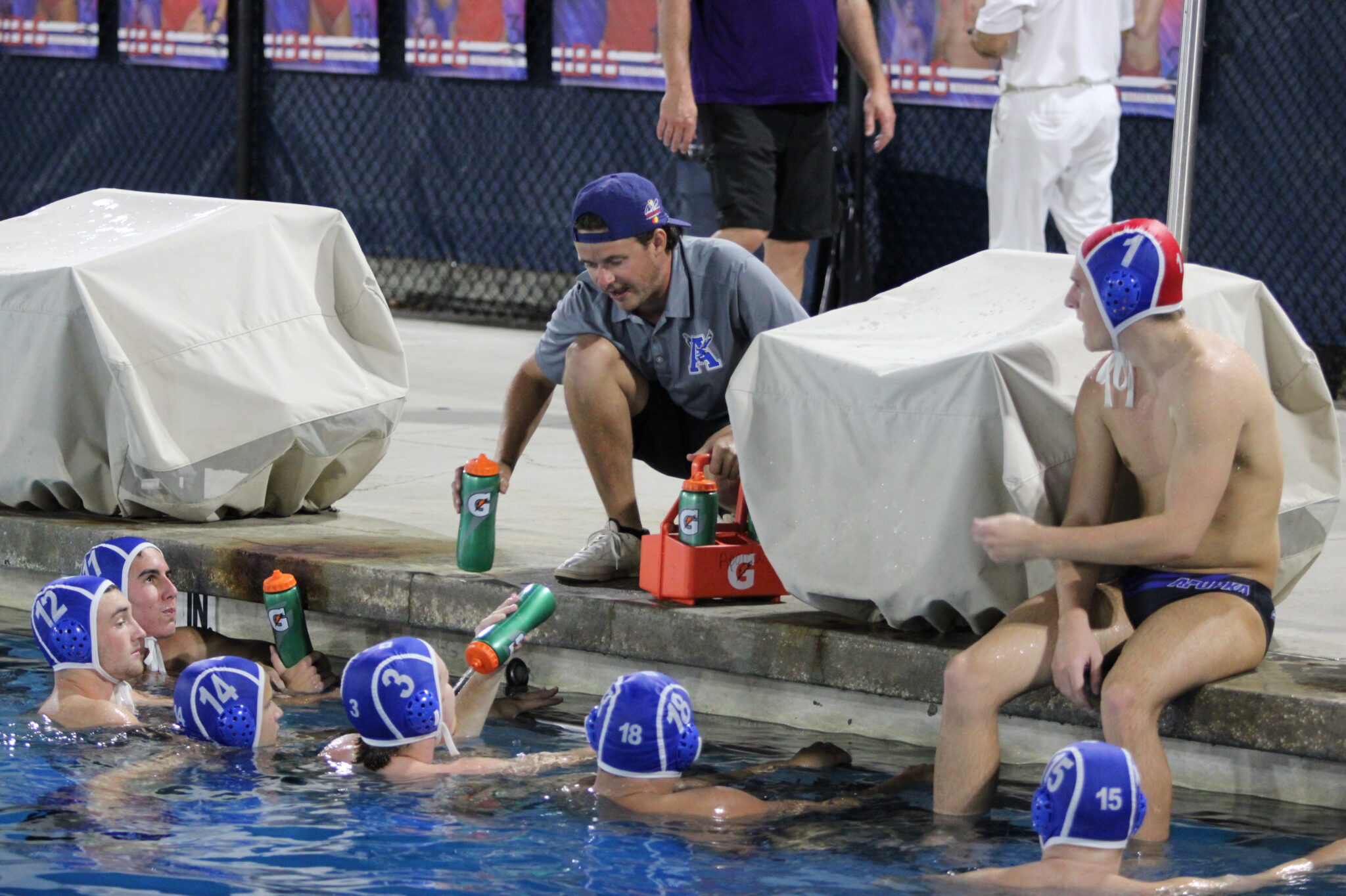 Boys coach Reide Wilson talks to and refreshes his players at the halftime break against Windermere