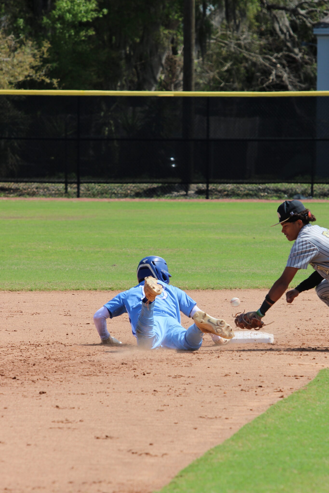 Bryce Doss gets back to second base during the pick-off attempt against Western