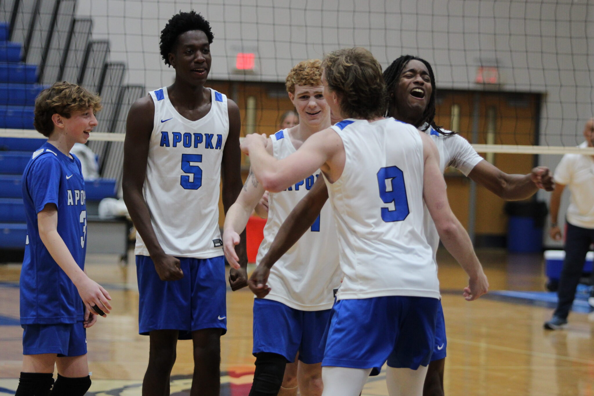 Caden McGatha and Elzie Robinson hug after connecting on a mircaulous play in the fourth set against Forest Lake Academy