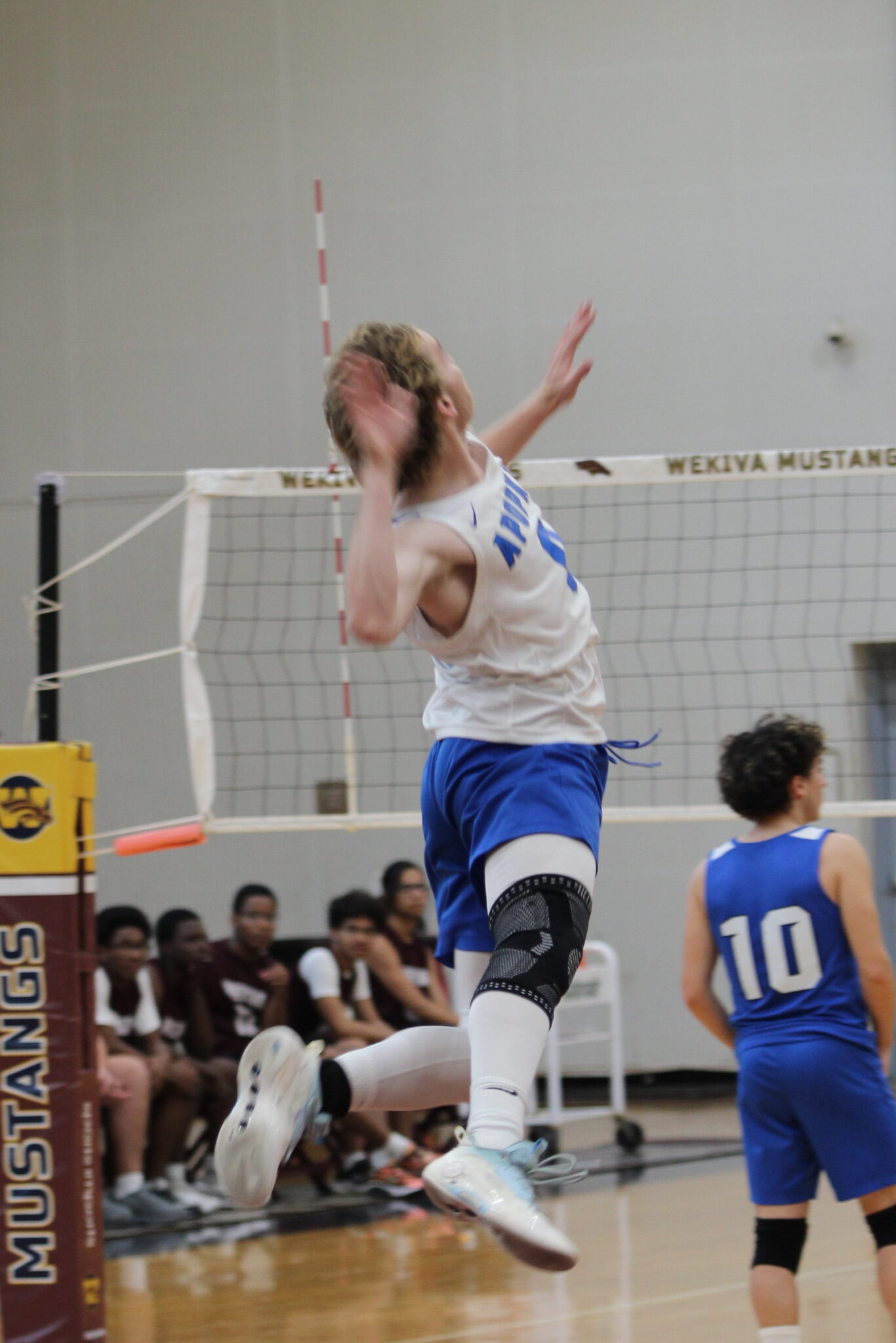 Caden McGatha rises up for his serve in the third set against Wekiva