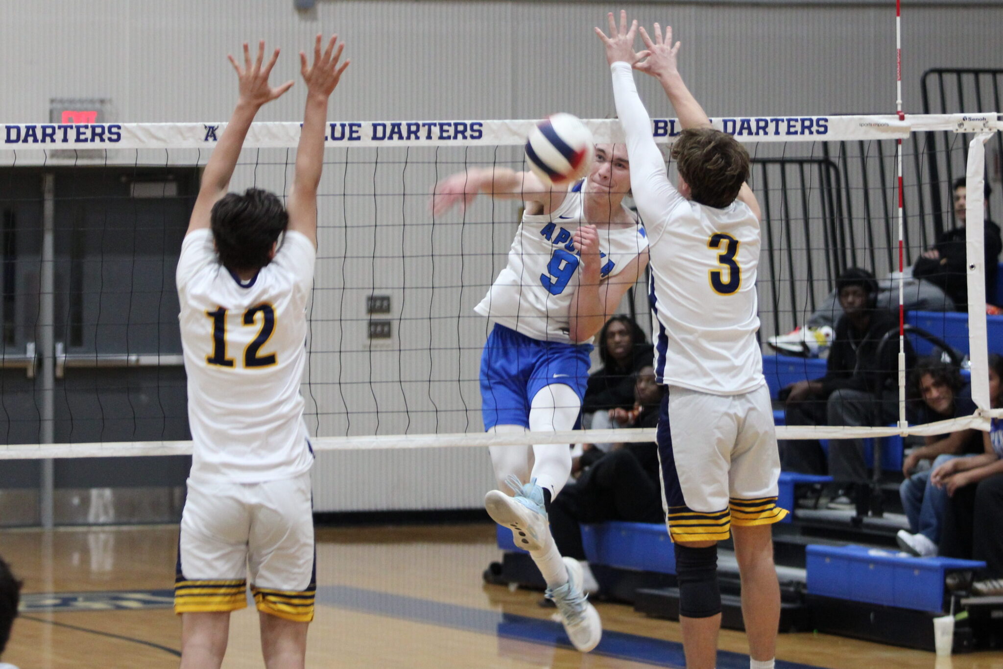 Caden McGatha smashes a kill in between two Panthers for a point