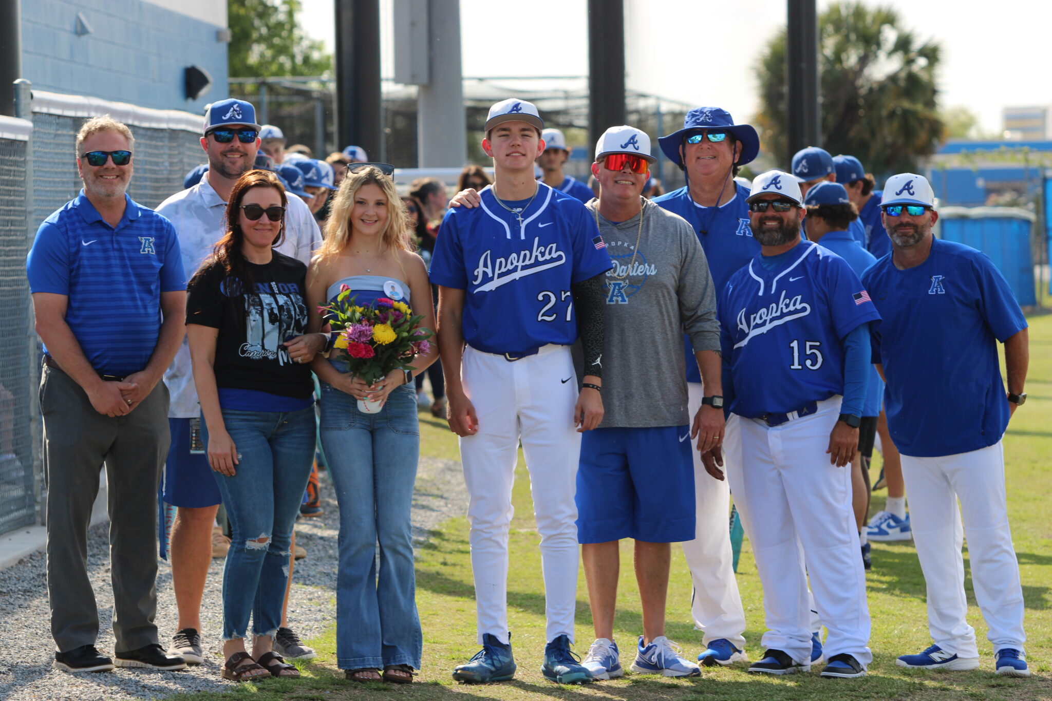 Camron Pennock with his family, coaches, Athletic Director Jordan Walker, and Principal Heinz on senior night