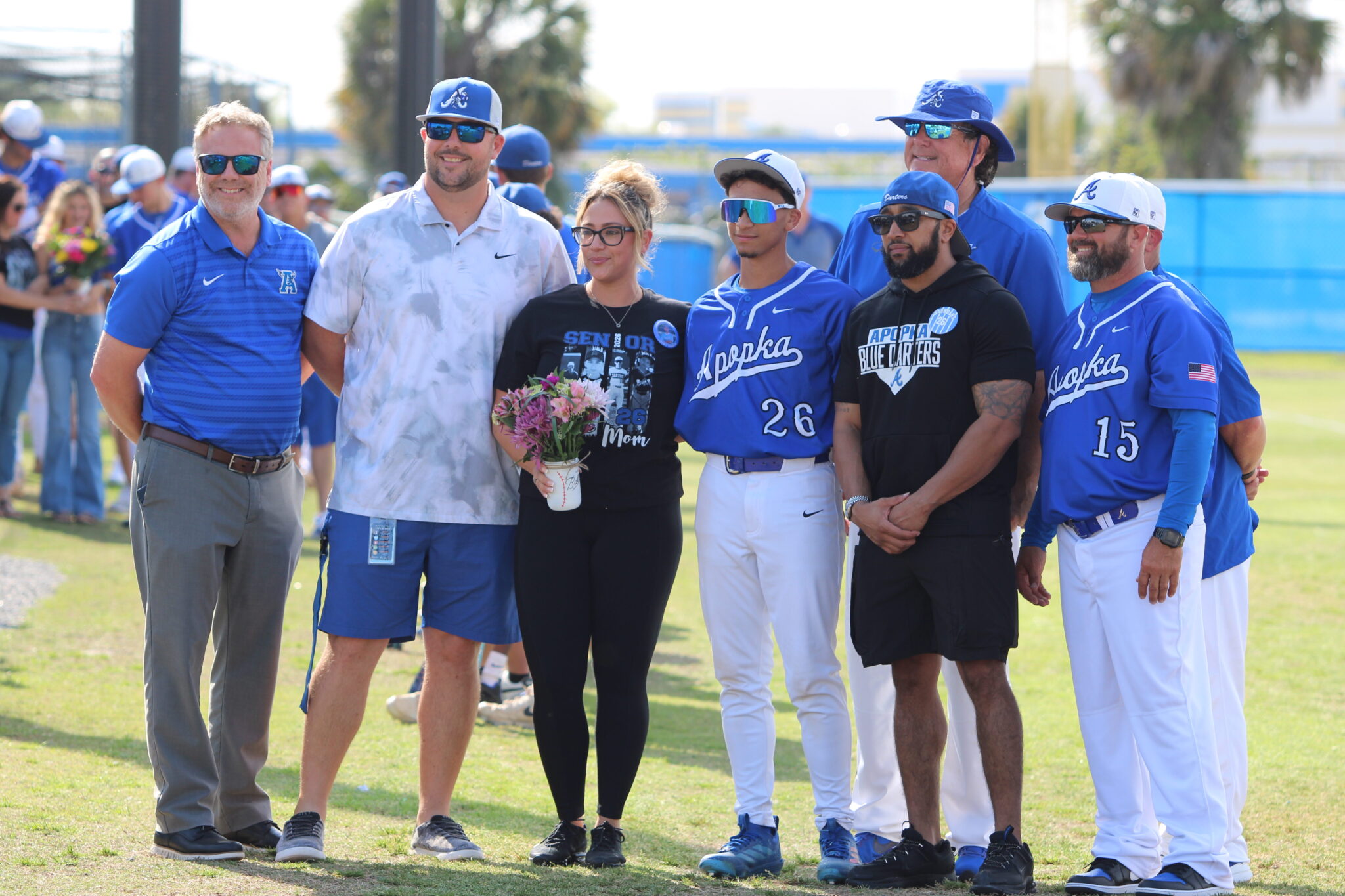Chance Saunders with his mother, father, coaches, Athletic Director Jordan Walker, and Principal Heinz on senior night