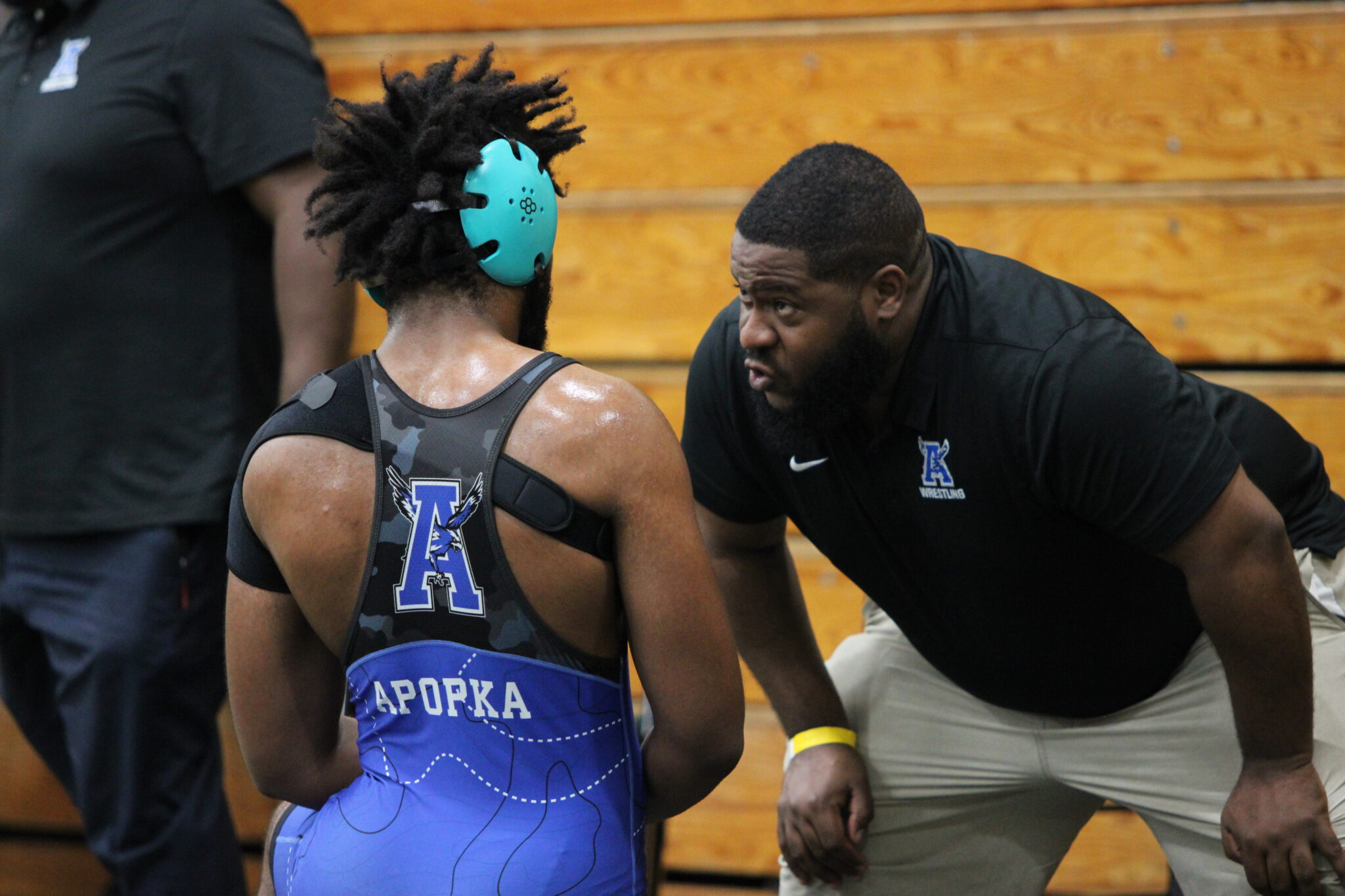 Coach Brian Blocker coaches up Brandon Roberts in between periods of the consolation round in the regional tournament