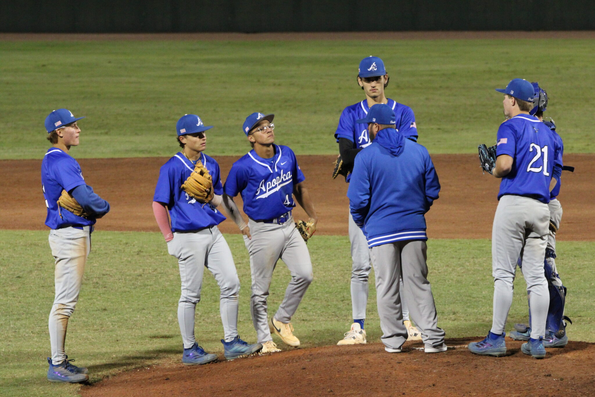 Coach Scott Garland takes a timeout to head to the mound and talk to the Blue Darter defense