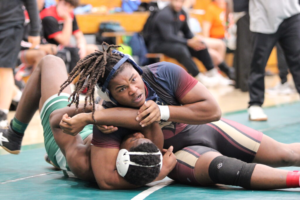 Elijah Jean holds his Flagler Palm Coast opponent planted on the ground as he works for a pin in the first round of the regional tournament