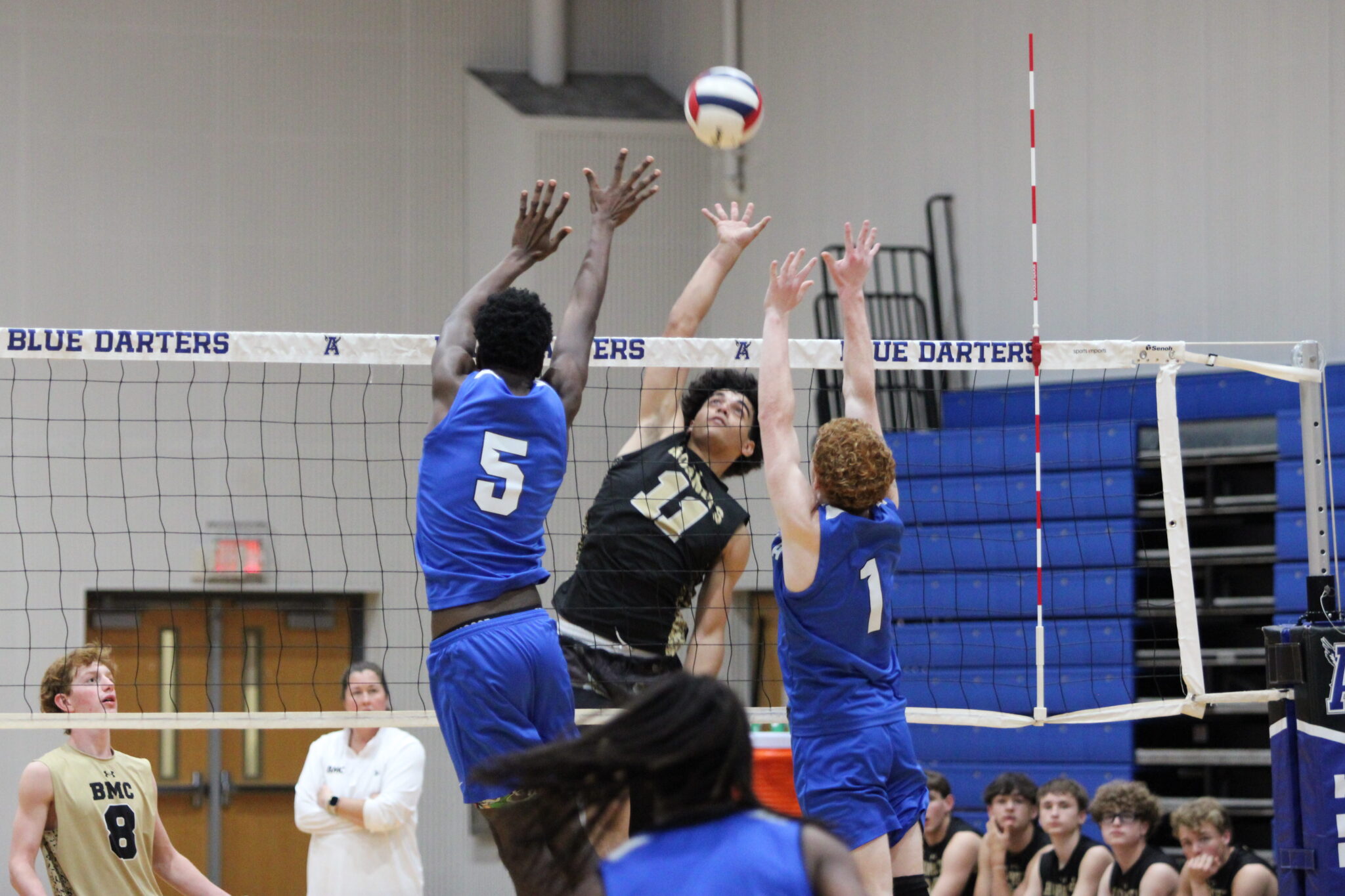 Giovanni Lubin (5) and Nathan White (1) reach up above the net in attempt to block a kill