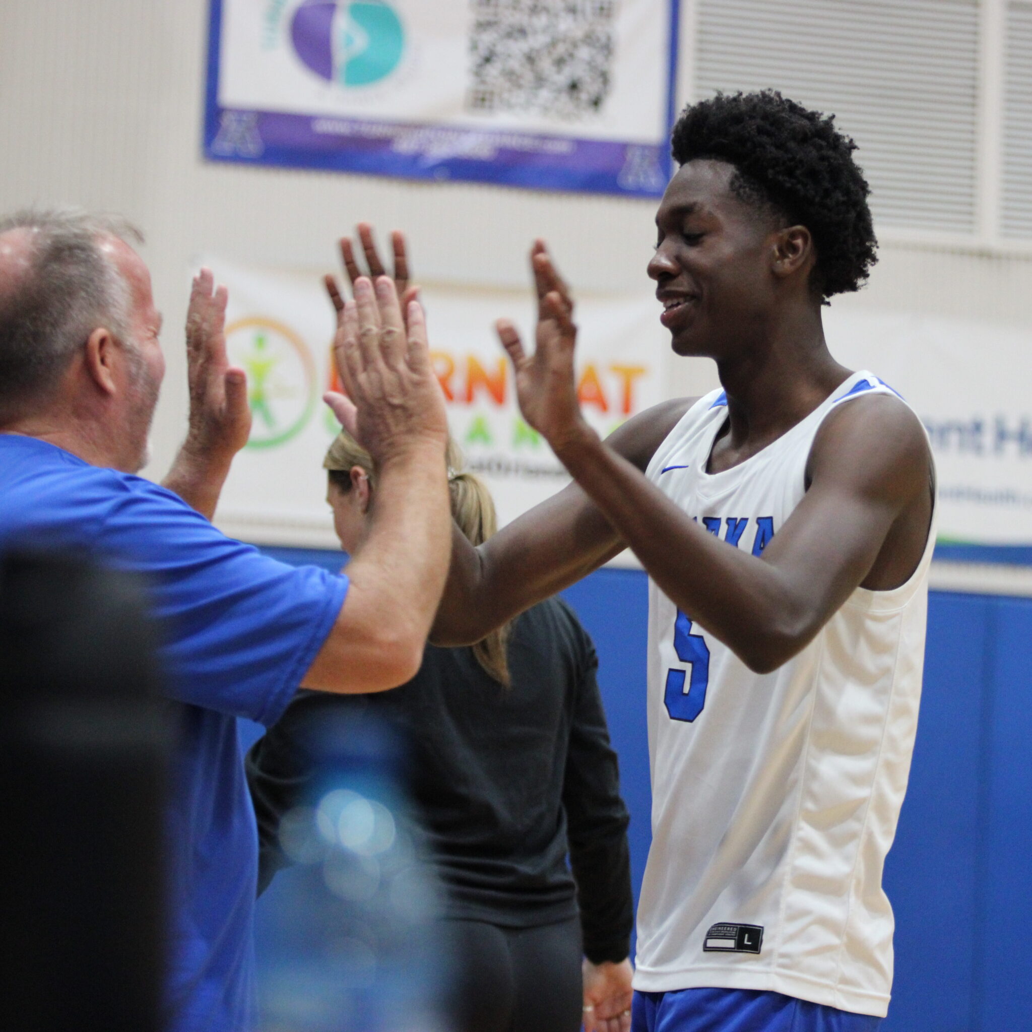 Giovanni Lubin comes off the court smiling after his block against Horizon