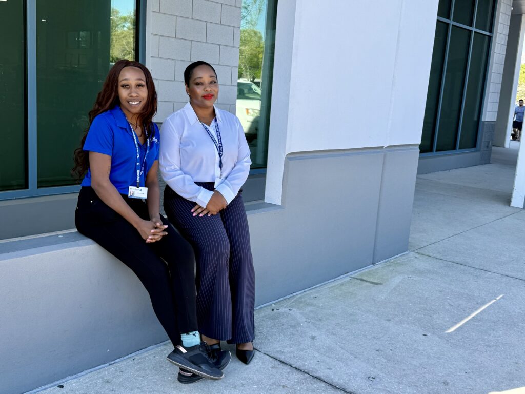Jacarra Mallard (left) and Jodie Foster (right) sit outside Goodwill Apopka.
