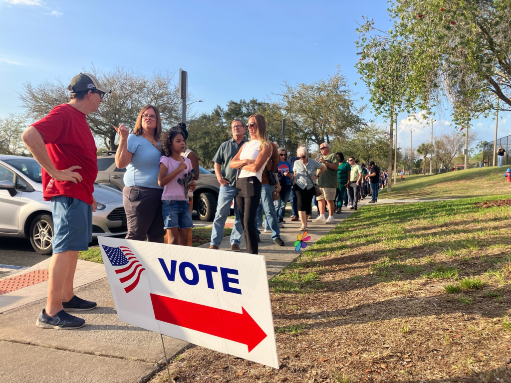 On Tuesday, voters wait outside a building at the Northwest Recreation Complex to cast their ballots.