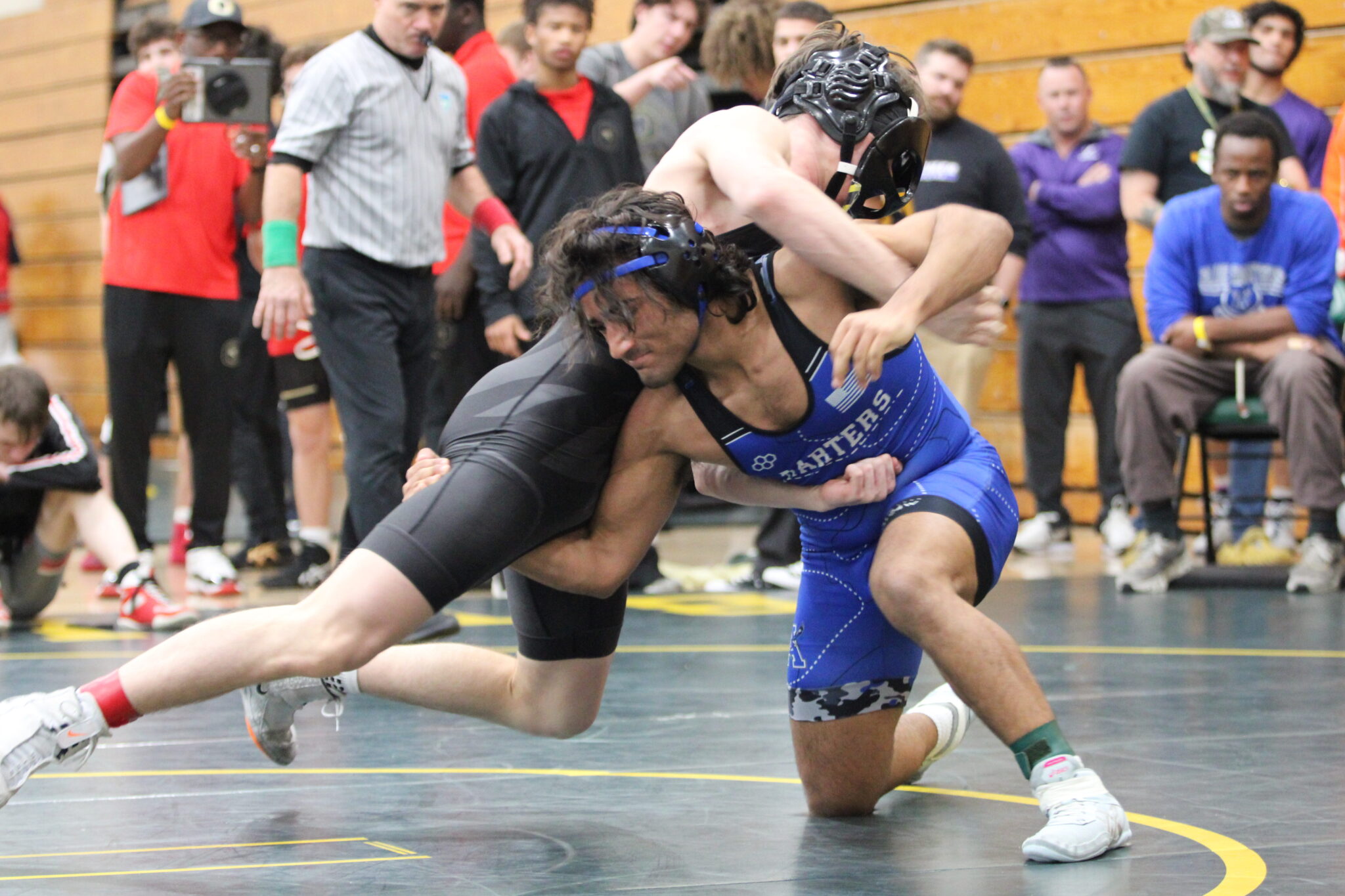 Ian Hernandez shoots for a single leg in the first round of the tournament against Oviedo