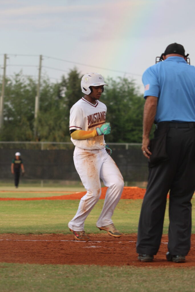 Jaden Graham crosses home plate after the passed ball thrown to third base