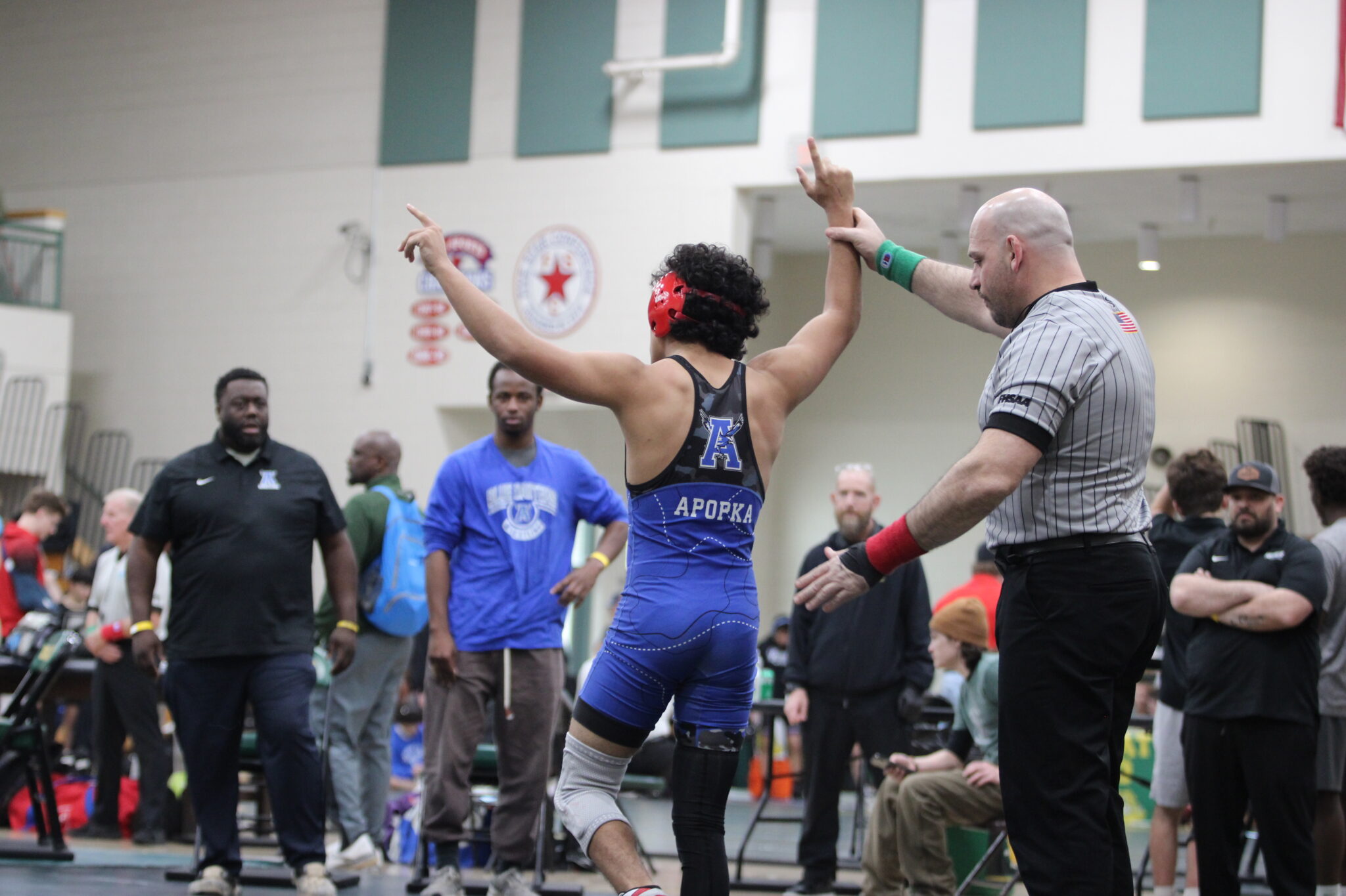 Julian Rivera gets his hand raised in the first round of the regional tournament against a Lake Mary wrestler