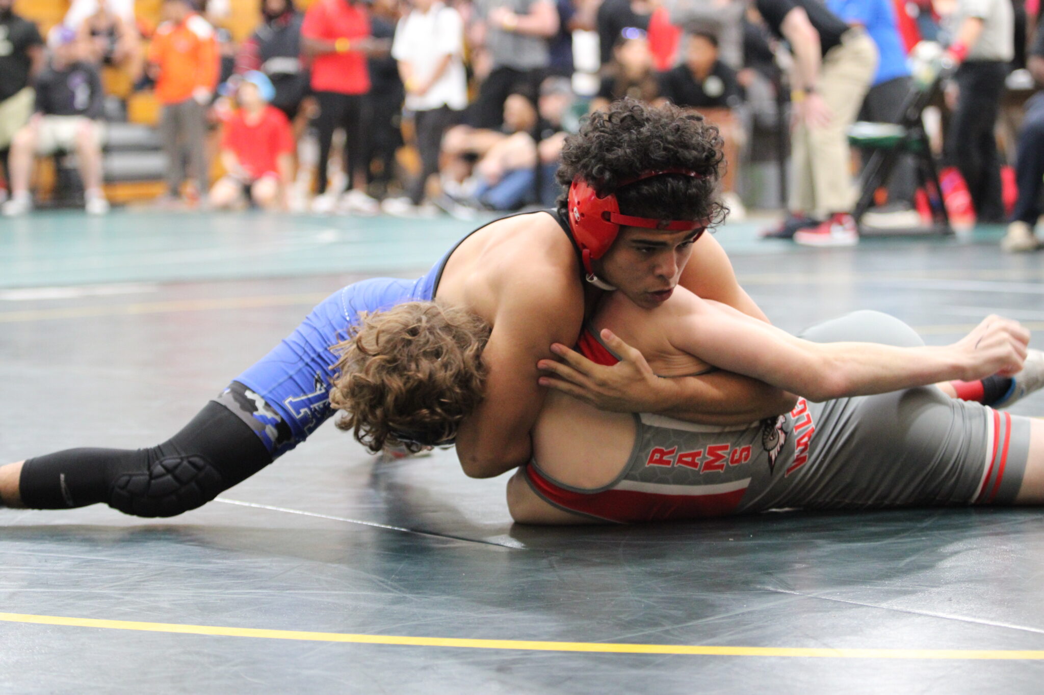 Julian Rivera locks the head of the Lake Mary wrestler and works the pin