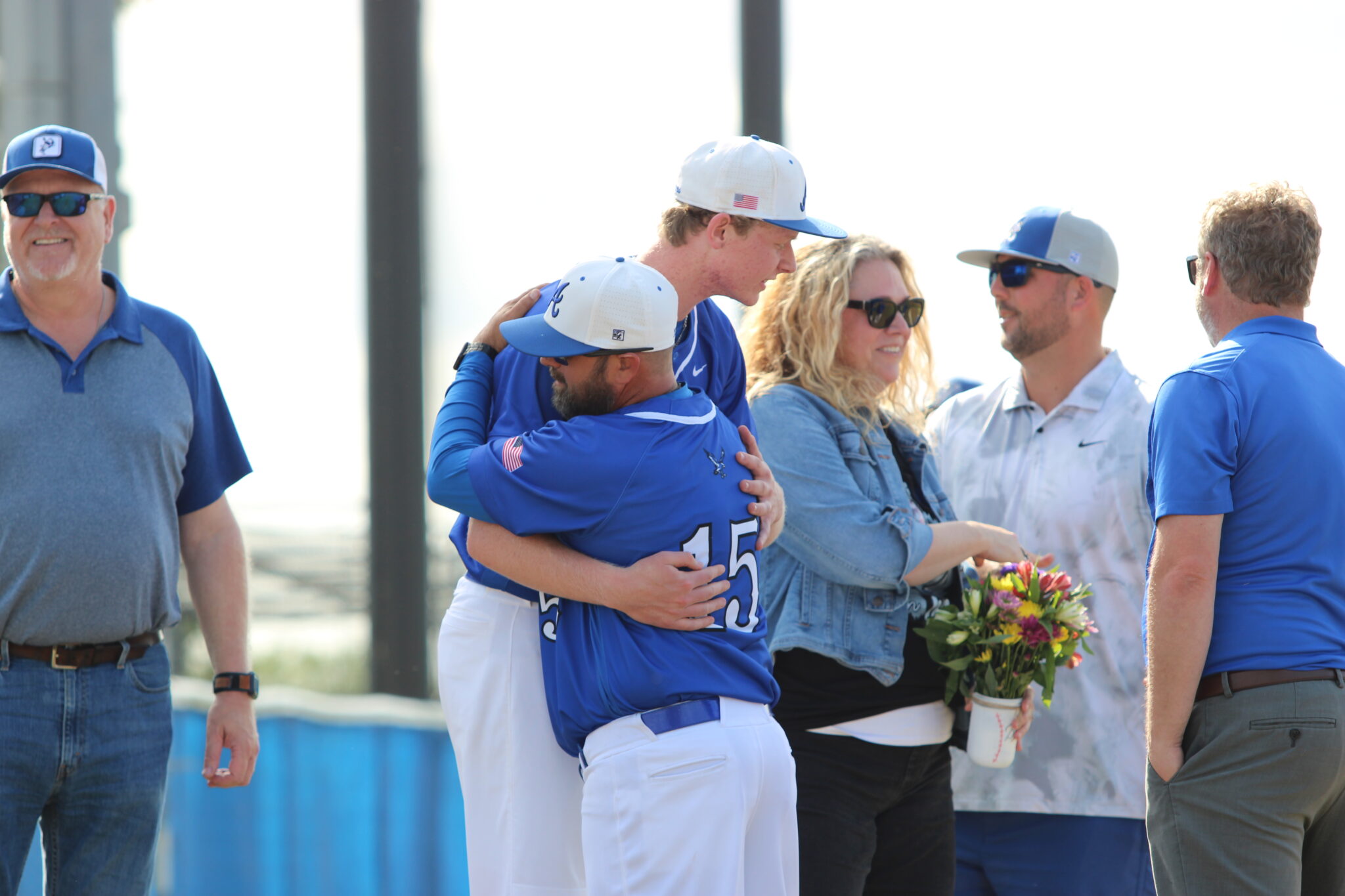 Logan Page and head coach Scott Garland share a big hug on senior night