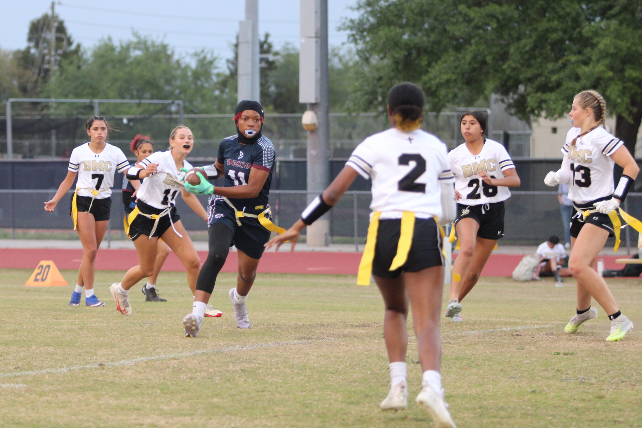 Makayla Bell catches the ball at midfield in between a swarm of Hornets