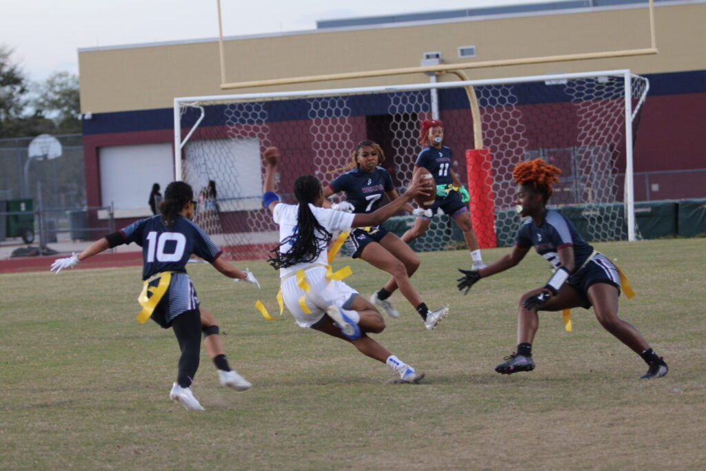 Mikayla Wiggins makes a move juking in between three Mustang defenders