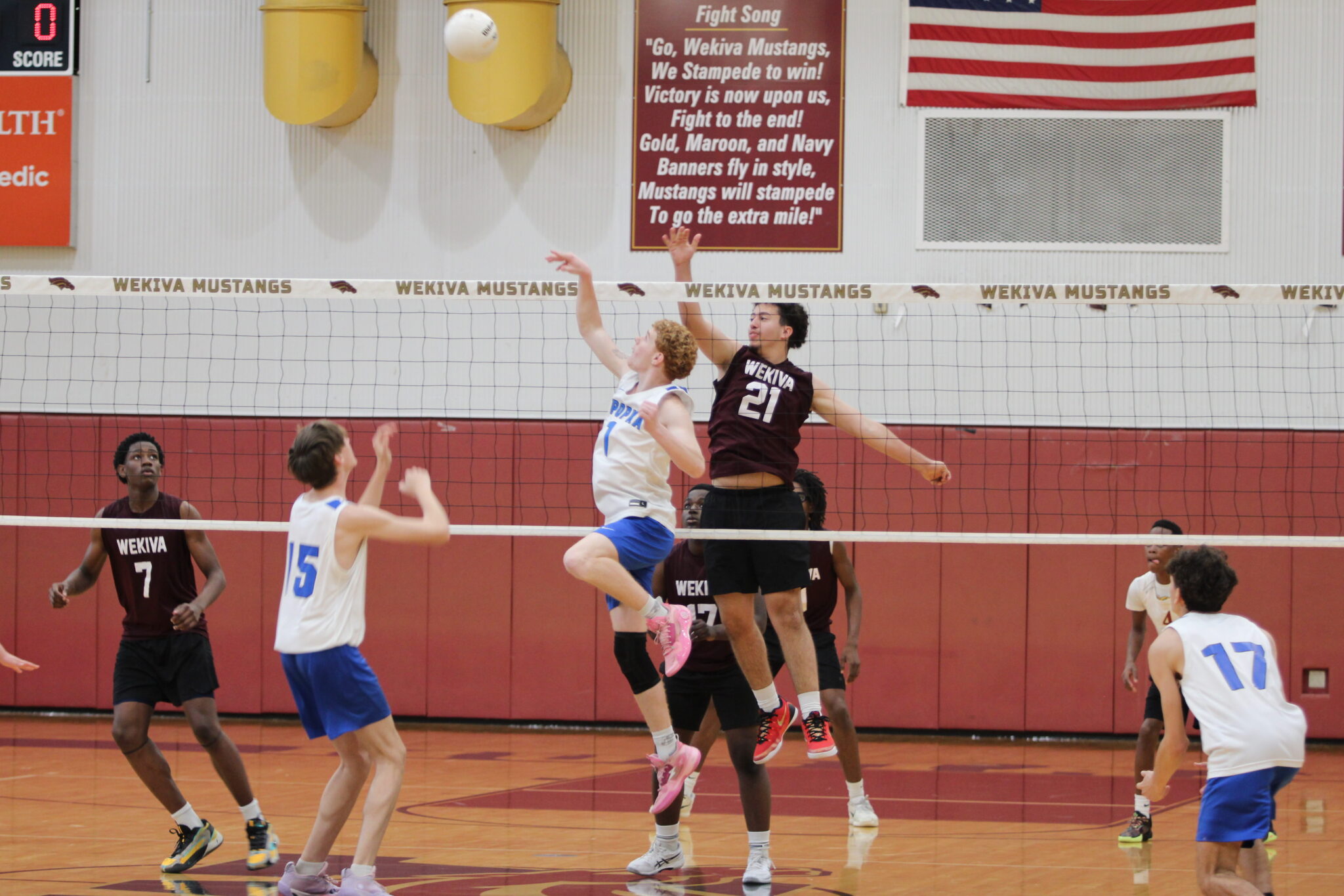 Nathan White passes the ball toward the left side of the net