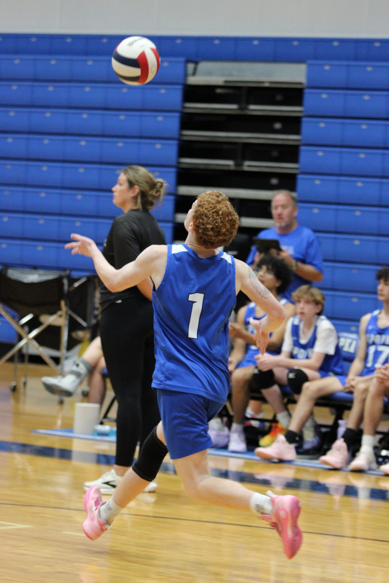 Nathan White prepares to smash a serve over to Bishop Moore