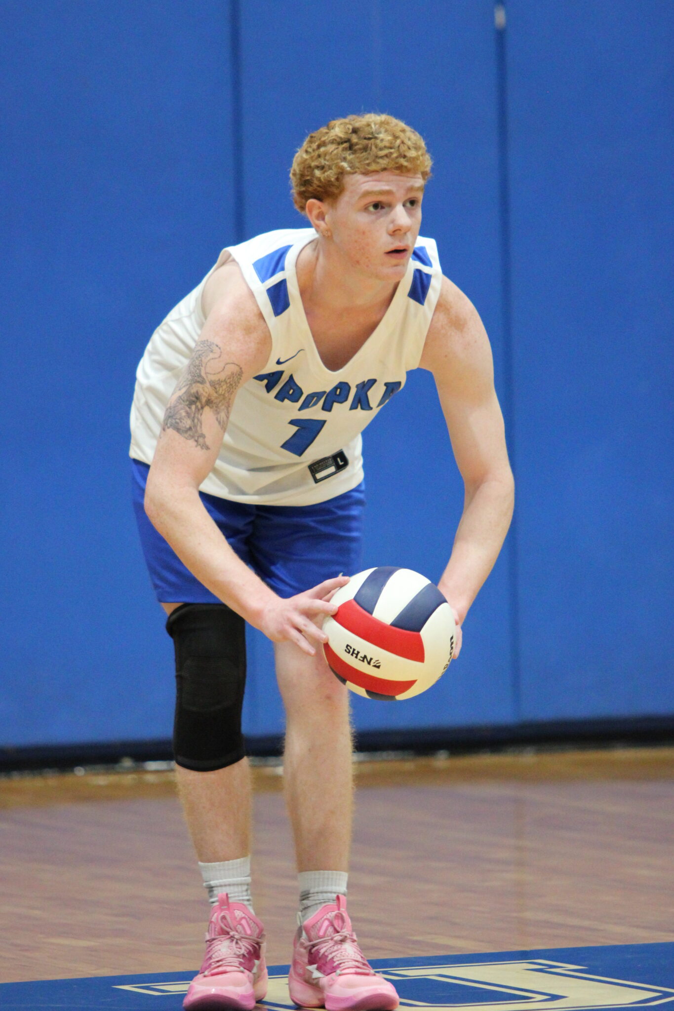Nathan White scans the court as he figures out where he will serve