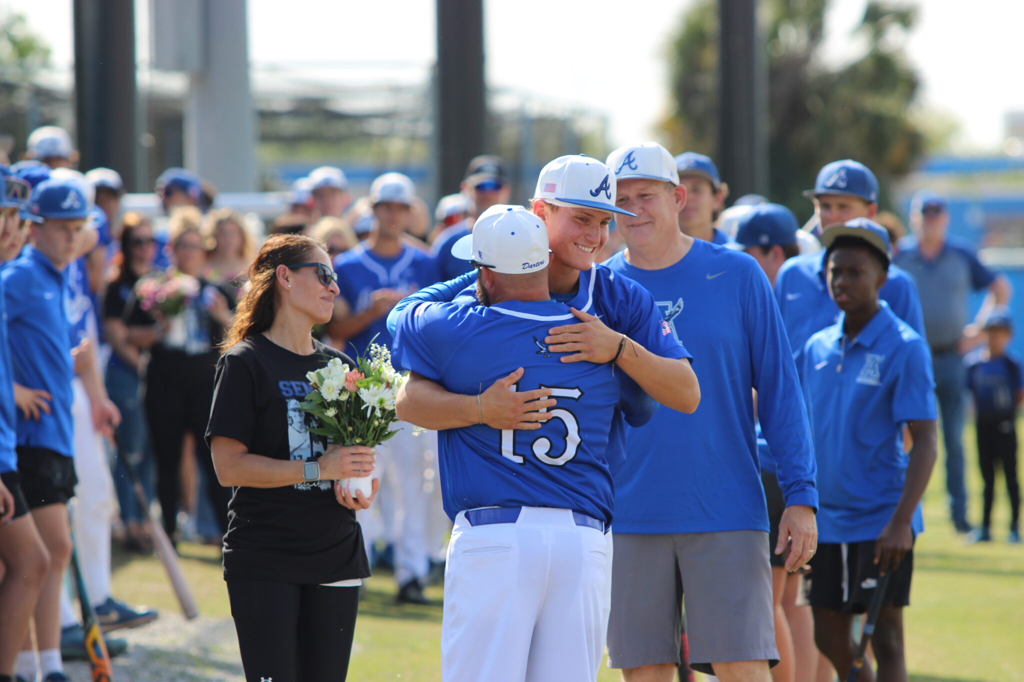 Nico Posluszny and head coach Scott Garland share a big hug on senior night