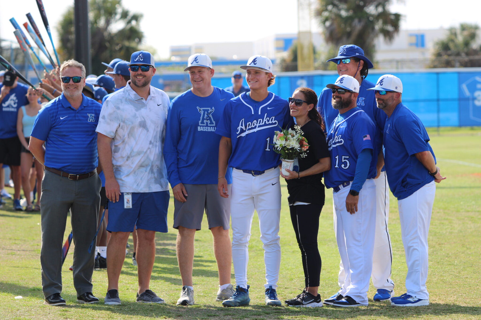 Nico Posluszny with his mother, father, coaches, Athletic Director Jordan Walker, and Principal Heinz on senior night