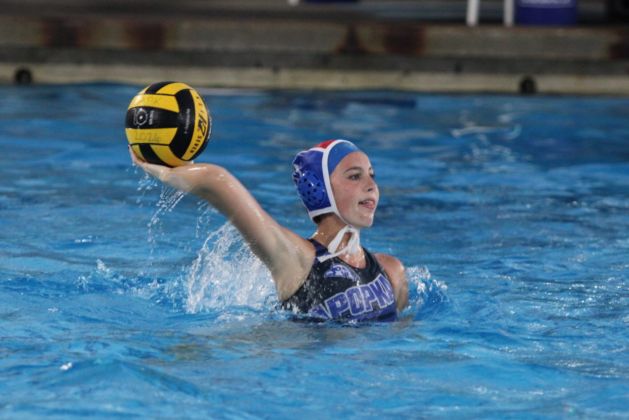 Reilly Batchelor winds back to throw the ball up the pool to her teammate