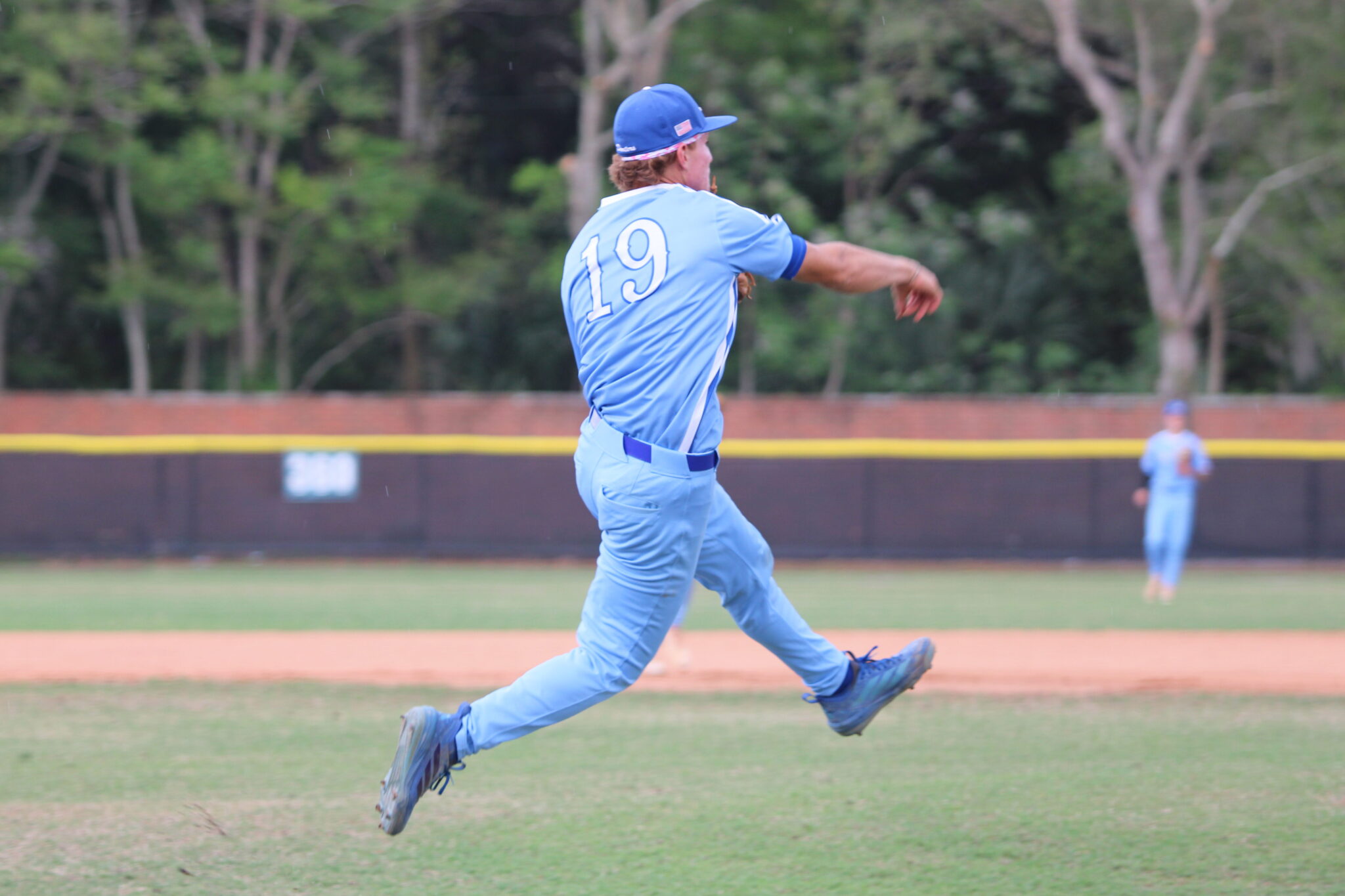 Senior Nico Posluszny makes a great throw on the run to first base against Olympia