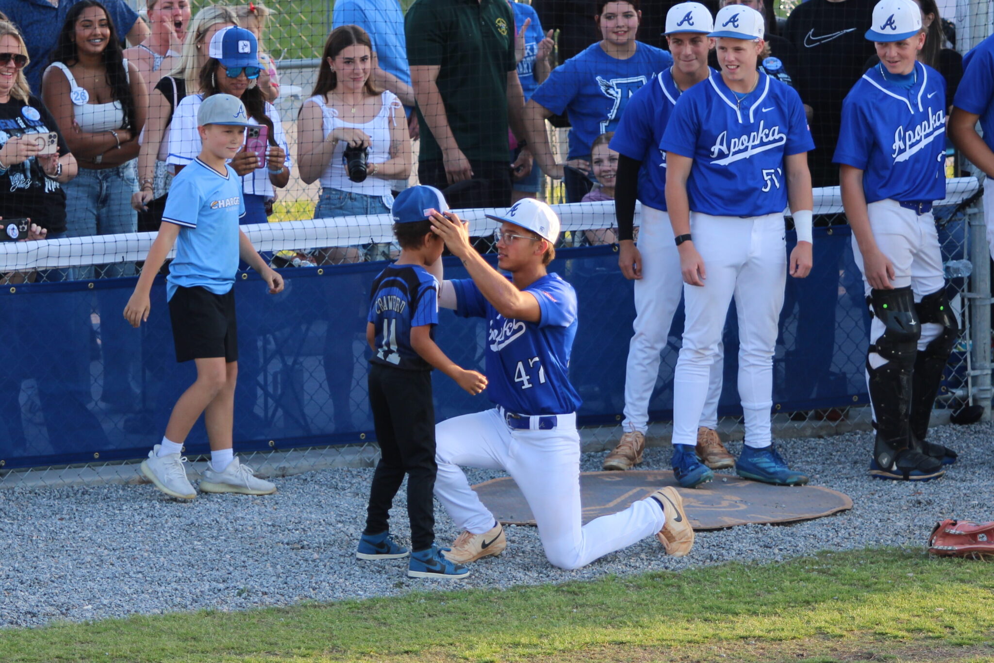 Ty Livingston gets introduced in the starting lineup on senior night and passes the torch to his little brother by putting a Blue Darter hat on his head