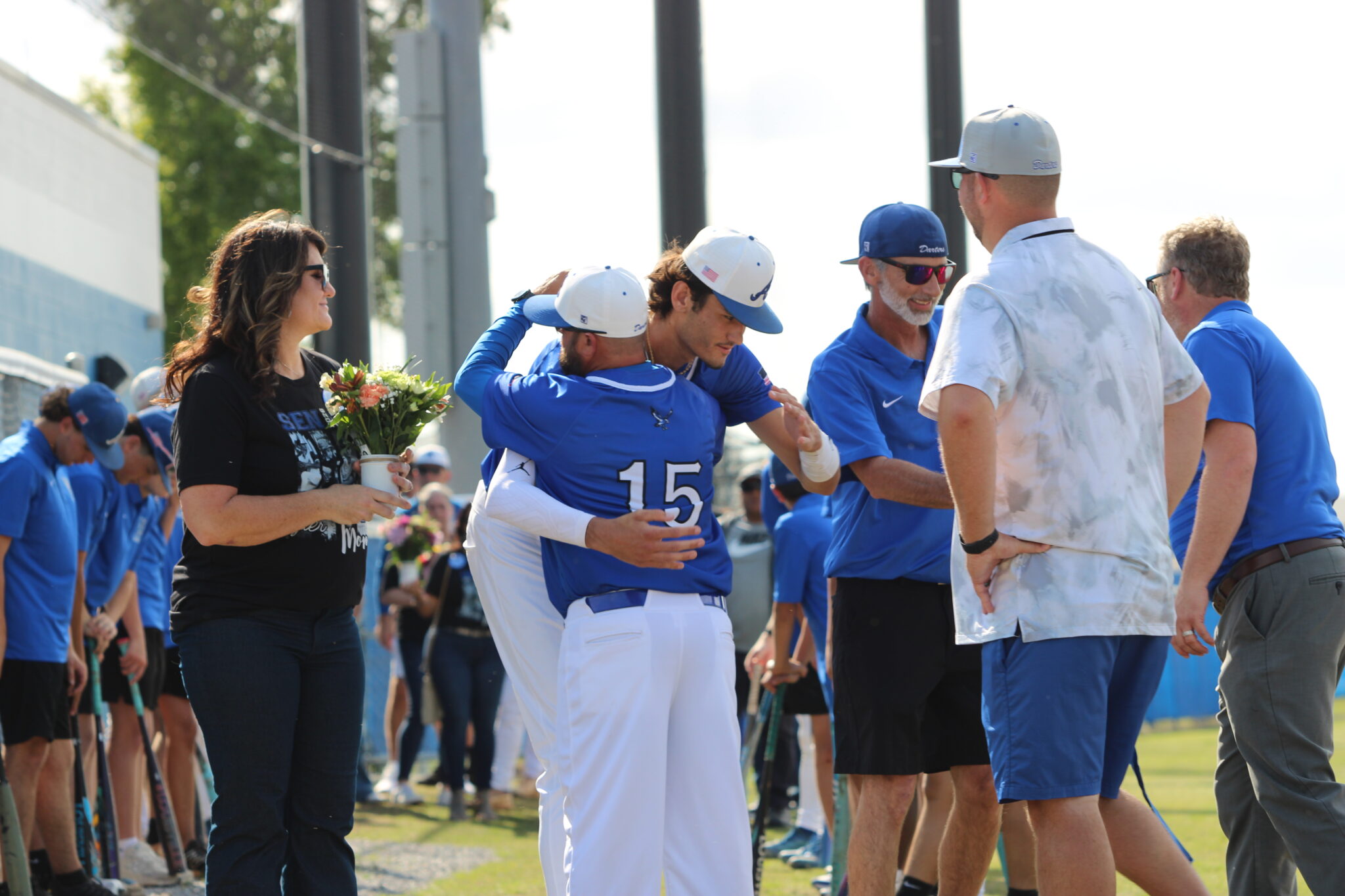 Tyler Spaid and head coach Scott Garland share a big hug on senior night