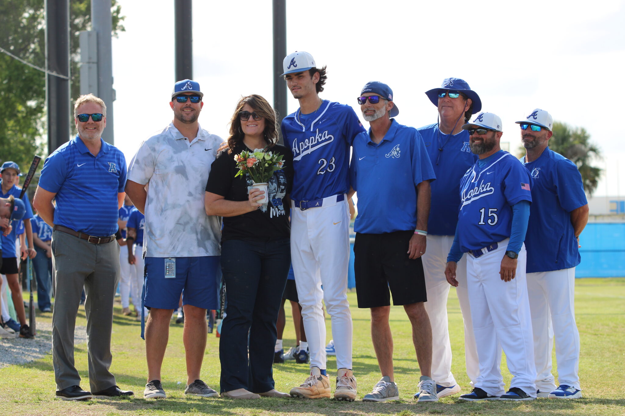 Tyler Spaid with his mother, father, coaches, Athletic Director Jordan Walker, and Principal Heinz on senior night