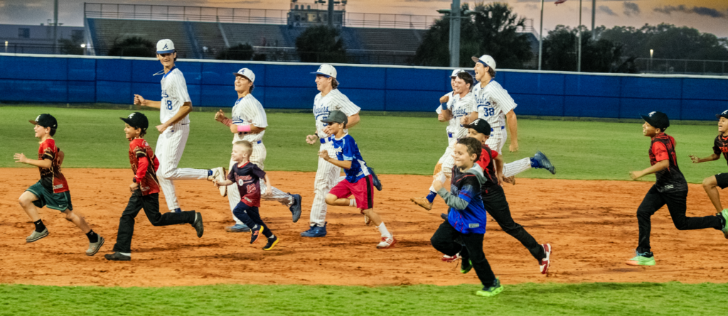 Little Leaguers were all smiles as they ran the bases with Blue Darter players.