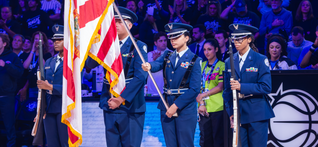 SrA Pacience Powell, Cadet 2nd LT William Warren, Major Emily Garcia, and Major Tarin Griffith stand at mid court presenting the nations colors during the National Anthem of Game 3 of the playoffs, Magic vs Pistons in the Kia Center