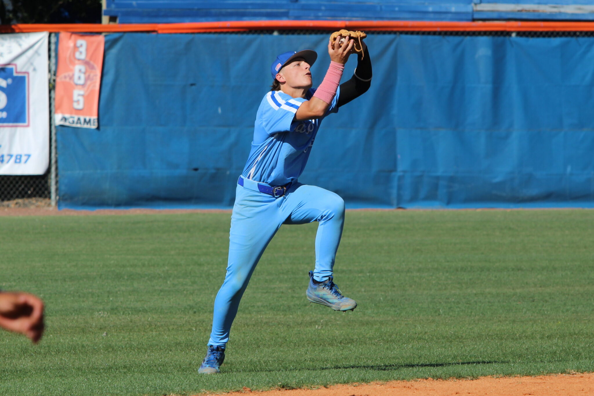 Aiden Rieli makes a grab at shortstop on a fly ball