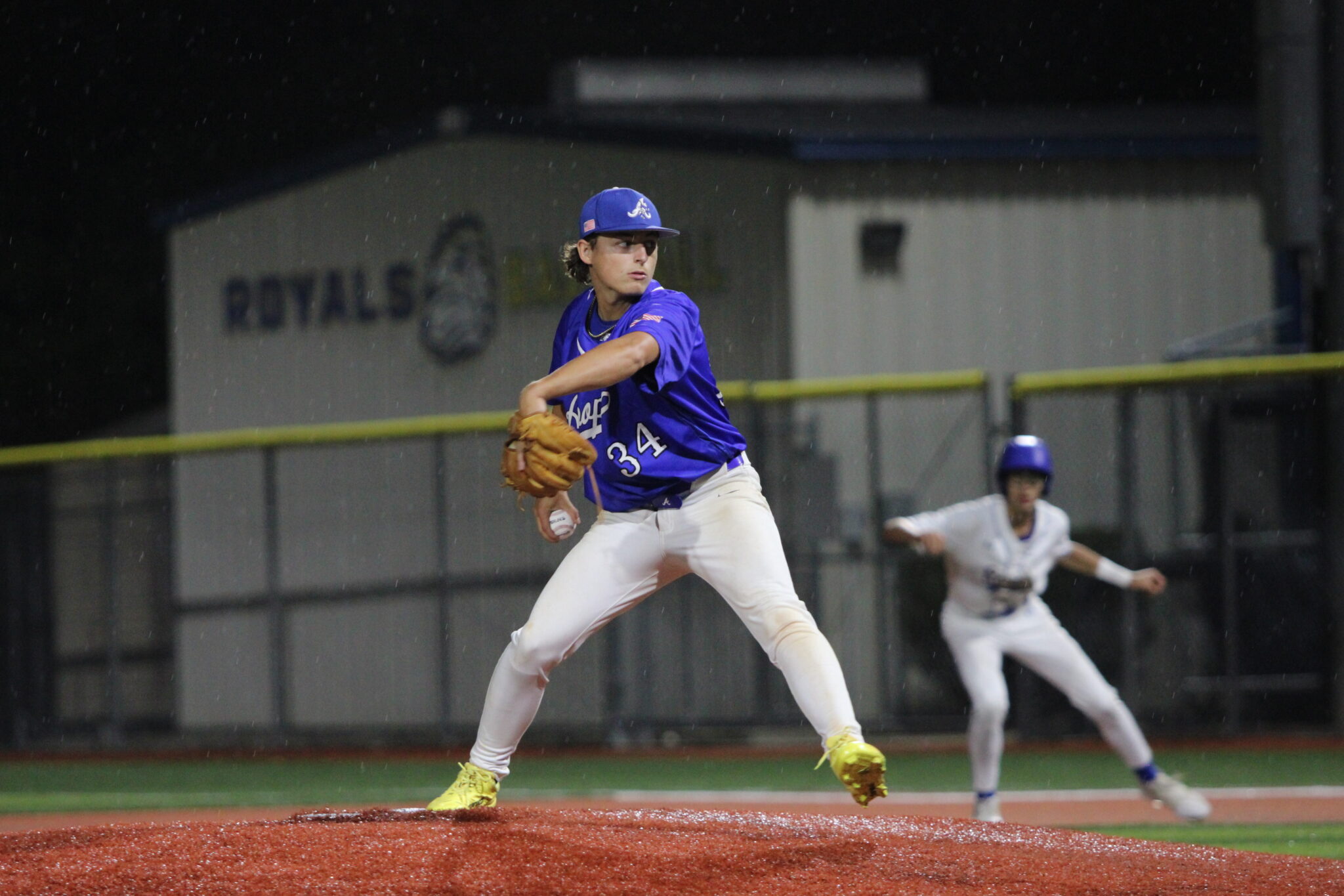 Aiden Rieli on the mound in relief, winds up a pitch
