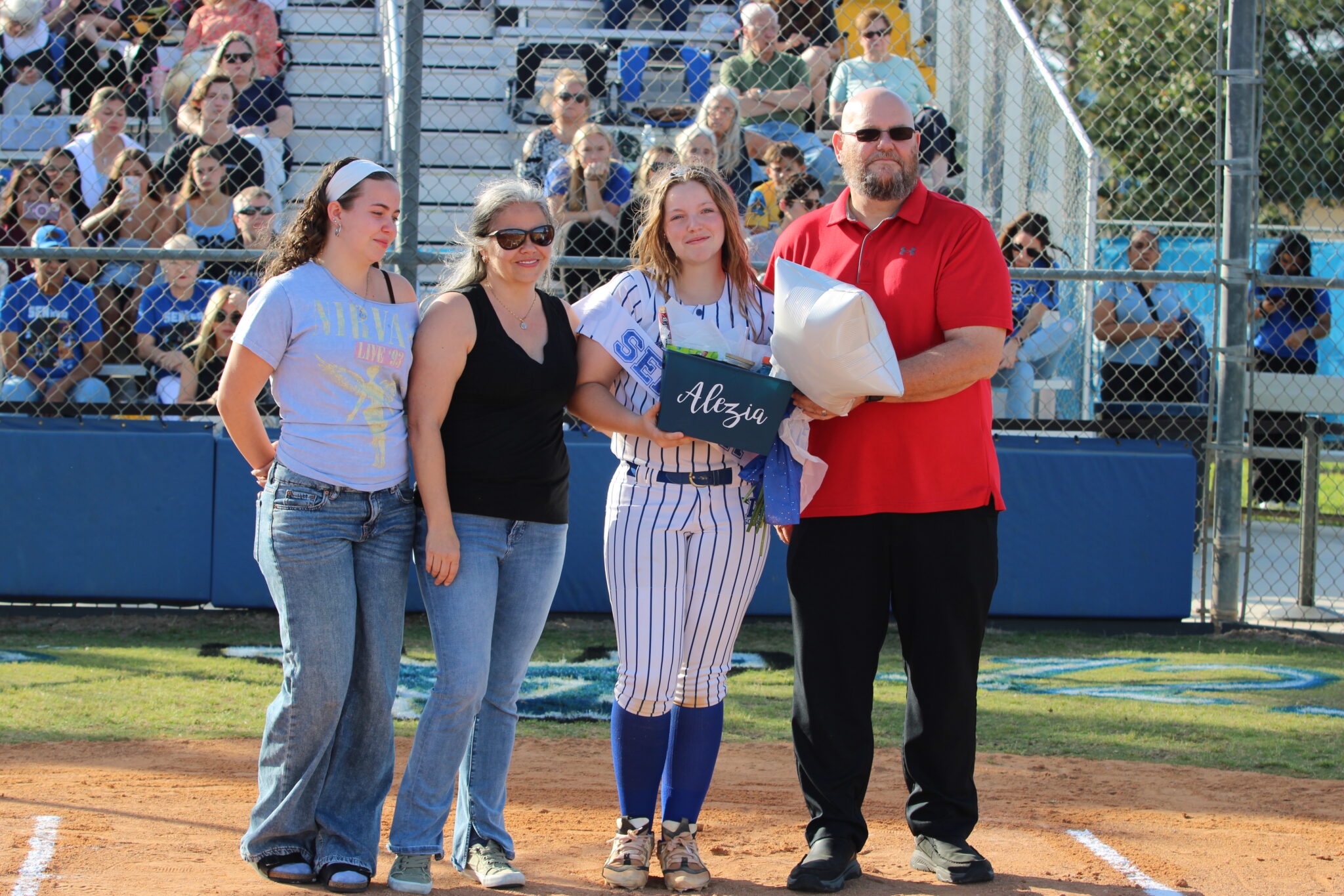 Alezia Hatcher poses with her family on senior night