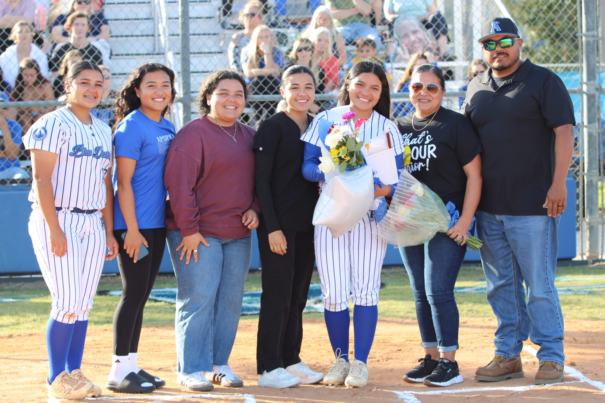 Alicia Lopez poses with her family on senior night